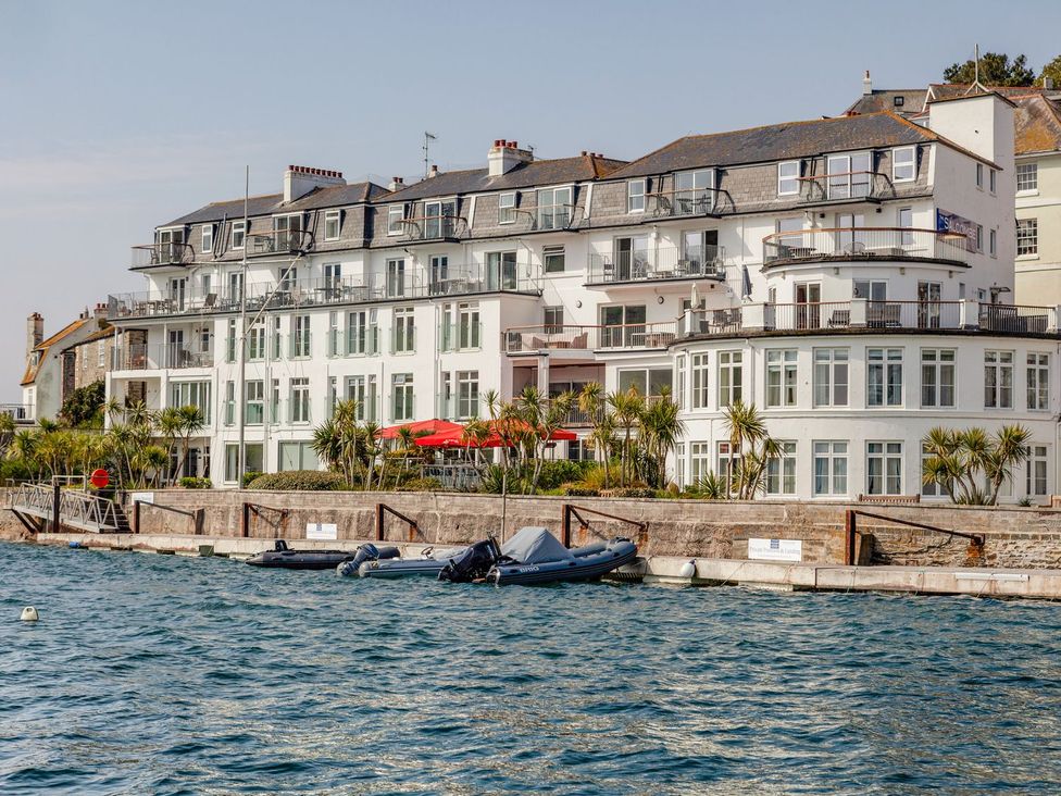 A view of a multi-story building with balconies and boats at 24 The Salcombe in Salcombe
