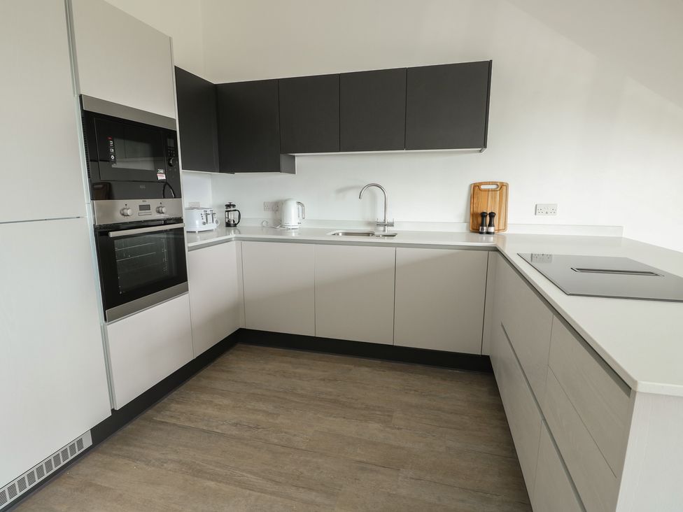 A kitchen with appliances and fixtures at Glynllifon 8 Marian-glas near Benllech