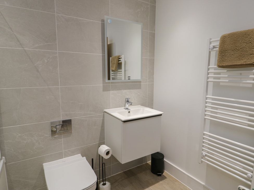 A bathroom with a sink and toilet at Glynllifon 8 Marian-glas near Benllech