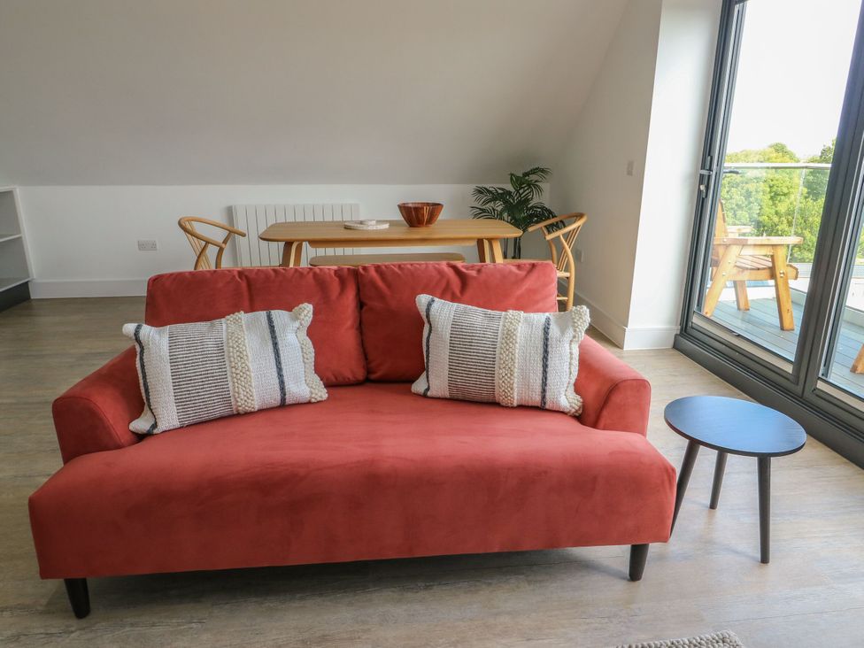 A living room with a sofa and table at Glynllifon 8 Marian-glas near Benllech