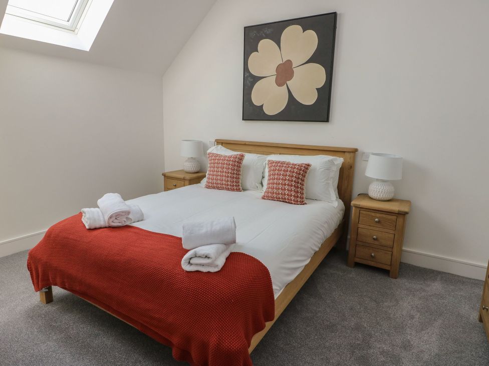 A bedroom with a double bed and nightstands at Glynllifon 8 Marian-glas near Benllech