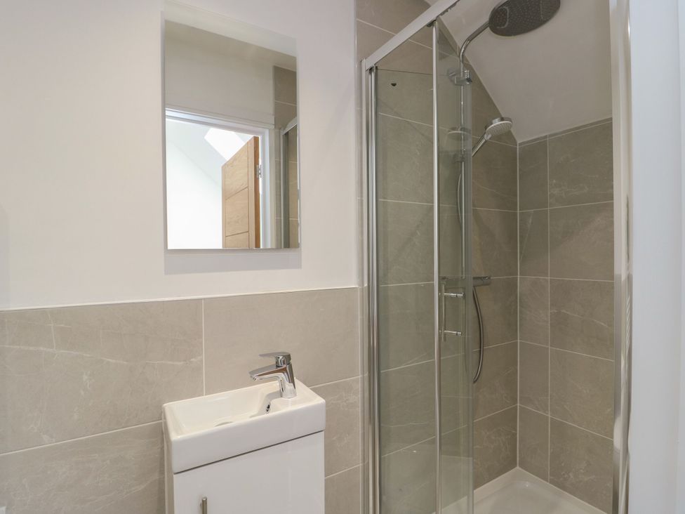 A bathroom with a shower and sink at Glynllifon 8 Marian-glas near Benllech