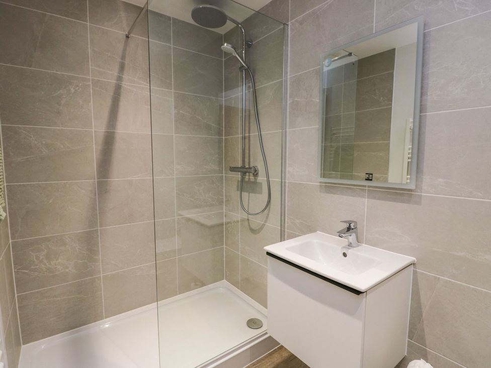A bathroom with shower and sink at Glynllifon 8 Marian-glas near Benllech