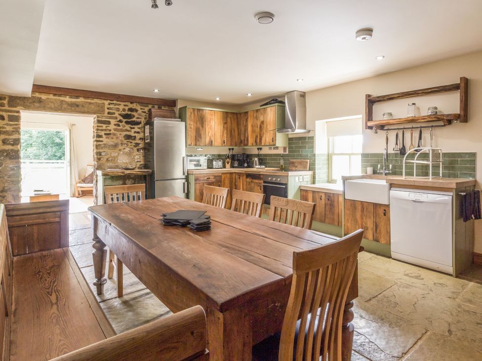 A kitchen with a wooden table and chairs at Orchard Cottage in Durham