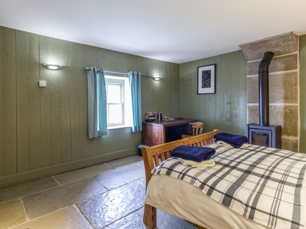 A bedroom with a bed and desk at Orchard Cottage in Durham