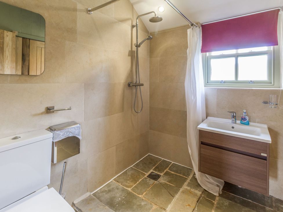 A bathroom featuring a toilet, sink, and shower at Orchard Cottage in Durham