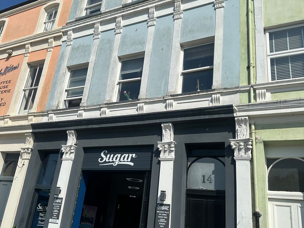 A building facade with signage and windows at Sugar loft in Silloth