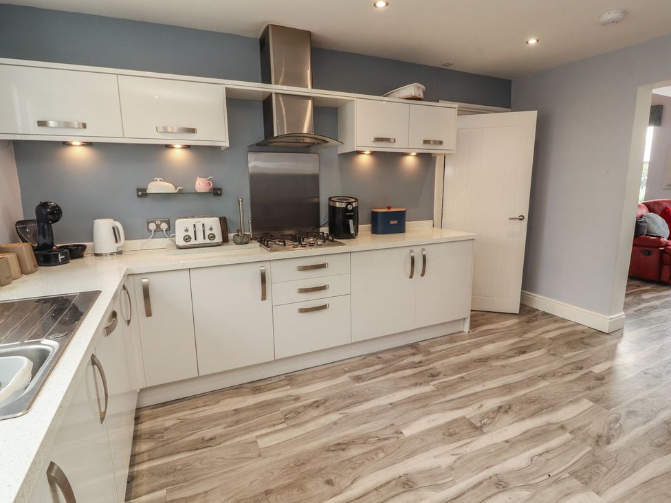 A kitchen with appliances and cabinets at Sugar Loft in Silloth