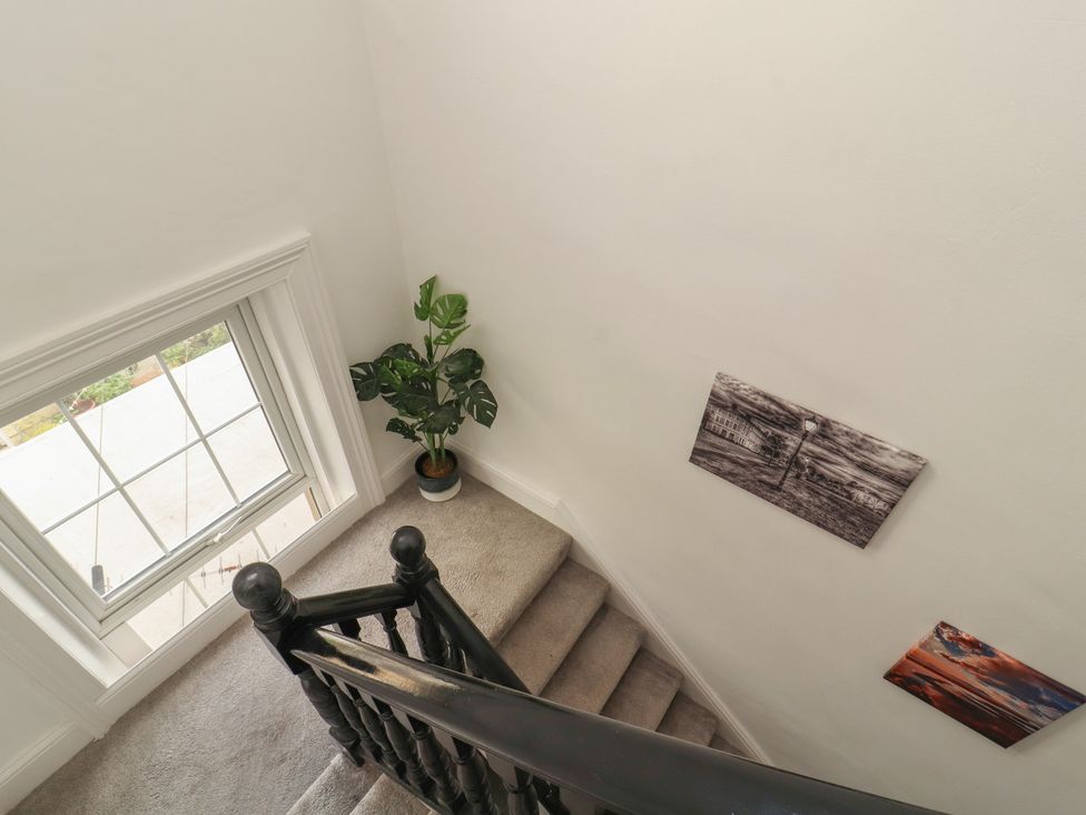 A stairway with carpet and window at Sugar Loft in Silloth