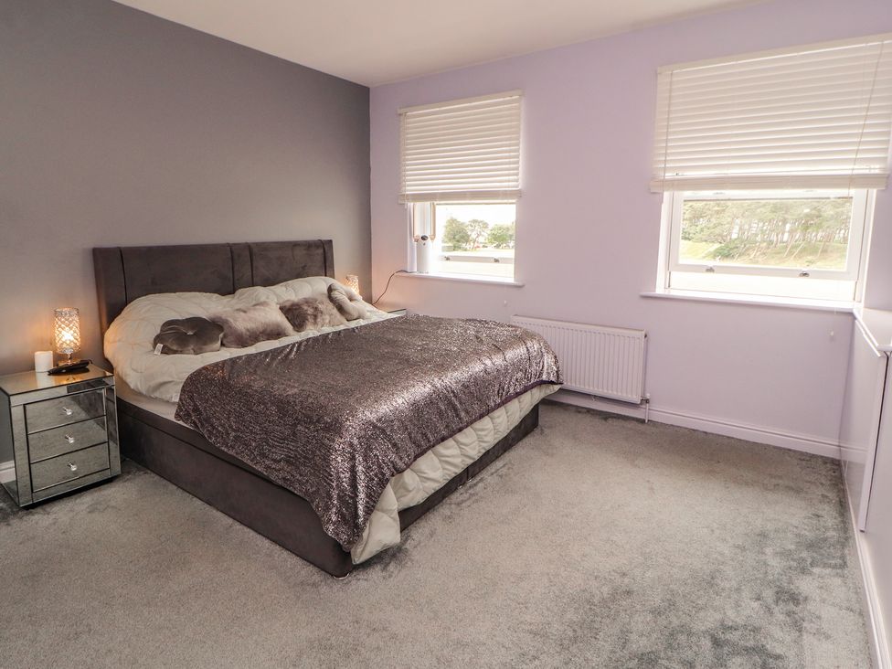 A bedroom with a bed and bedside table at Sugar Loft in Silloth