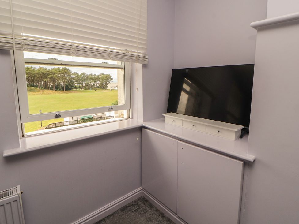 A room with a television and window at Sugar Loft in Silloth
