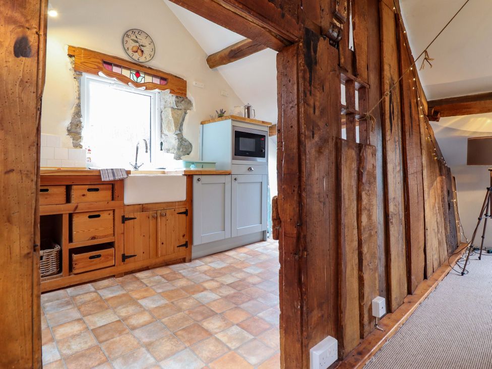 A kitchen with cabinets and a sink at Millers Loft in Llanrwst