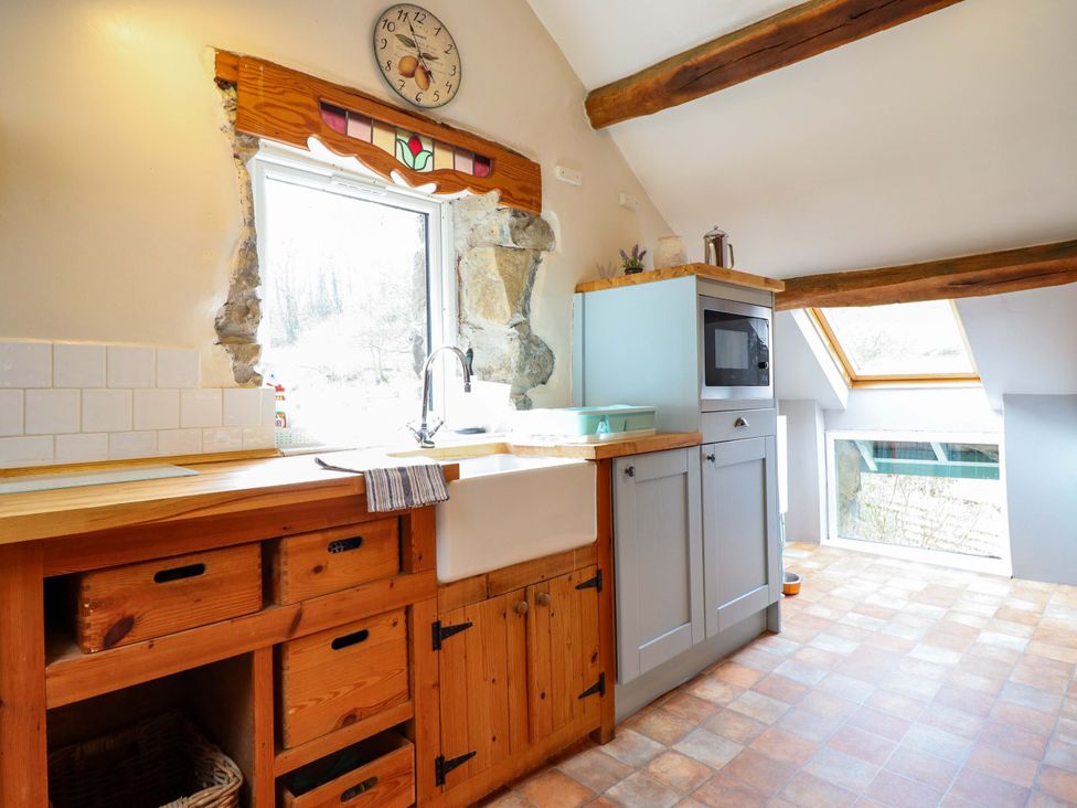 A kitchen with a sink and wooden countertops at Millers Loft in Llanrwst