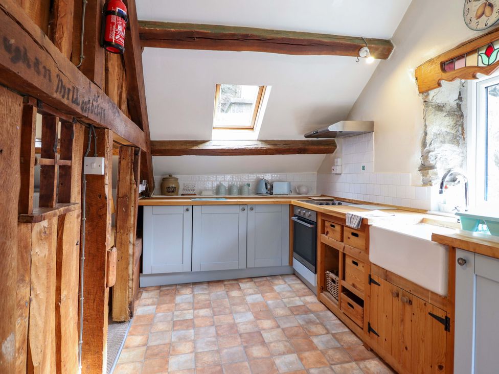 A kitchen with cabinets and a sink at Millers Loft in Llanrwst