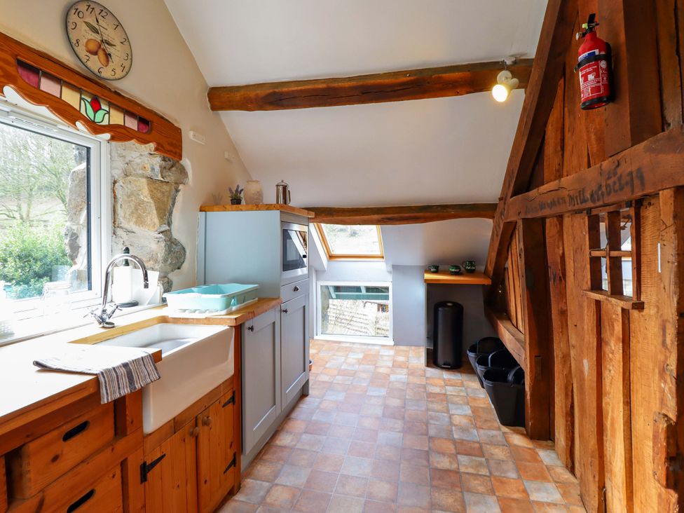 A kitchen with a sink and window at Millers Loft in Llanrwst