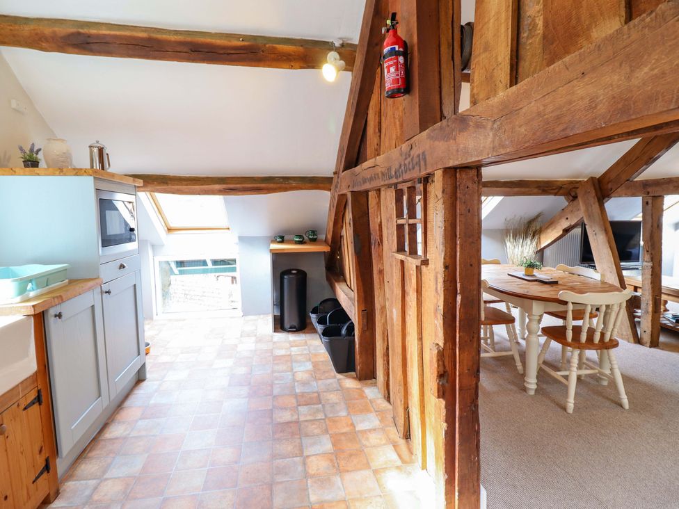 A kitchen with table and chairs at Millers Loft in Llanrwst