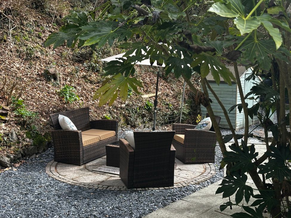 A garden area with seating and a table at Millers Loft in Maenan near Llanrwst