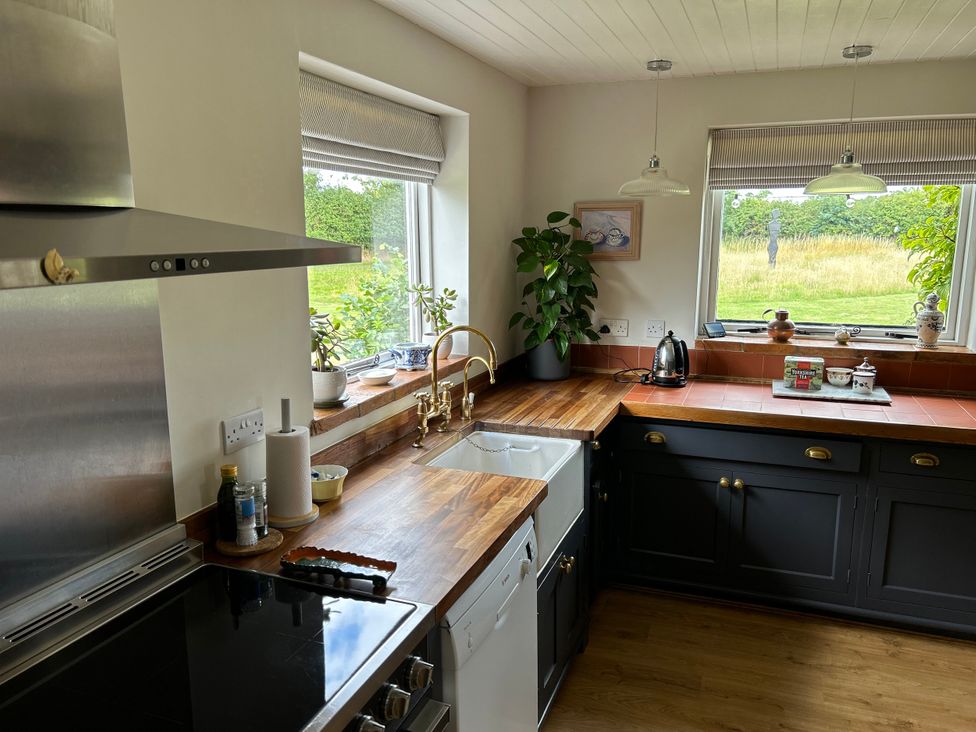 A kitchen with wooden countertops and stainless appliances at Cutbush Farmhouse Norwich