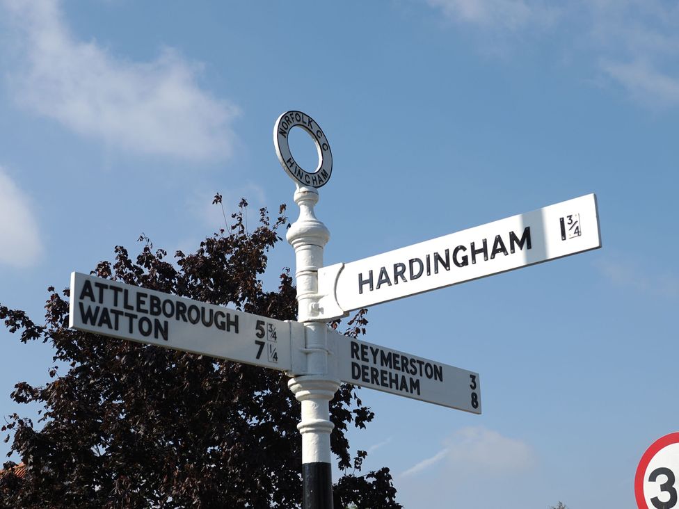 A signpost indicating directions to various locations at Cutbush Farmhouse in Norwich