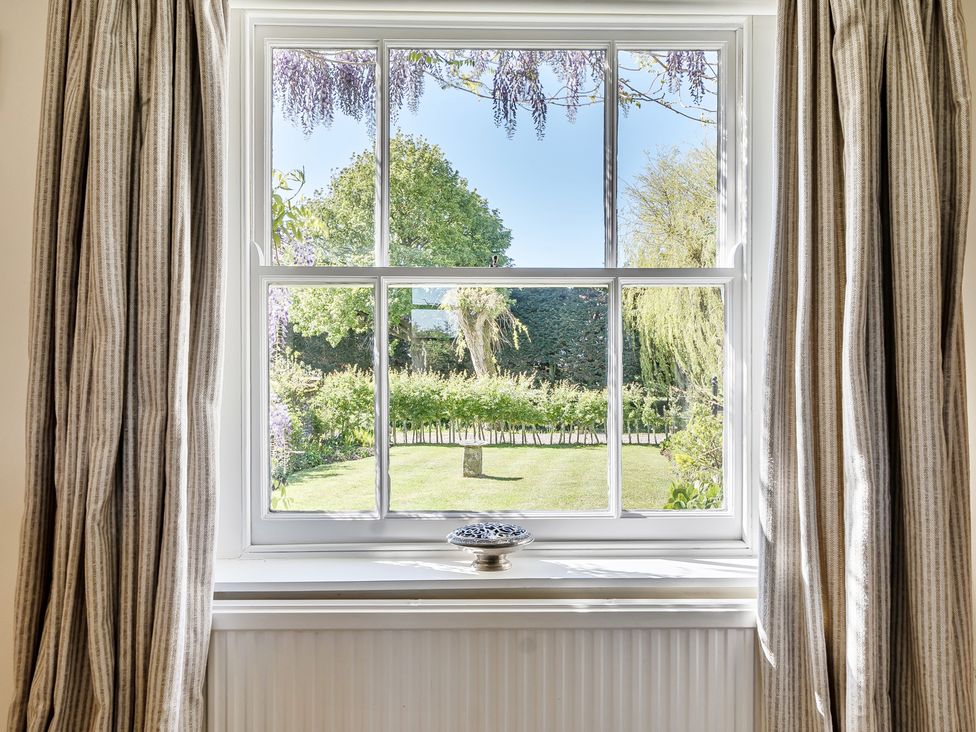 A window with a view of a garden at Cutbush Farmhouse in Hingham