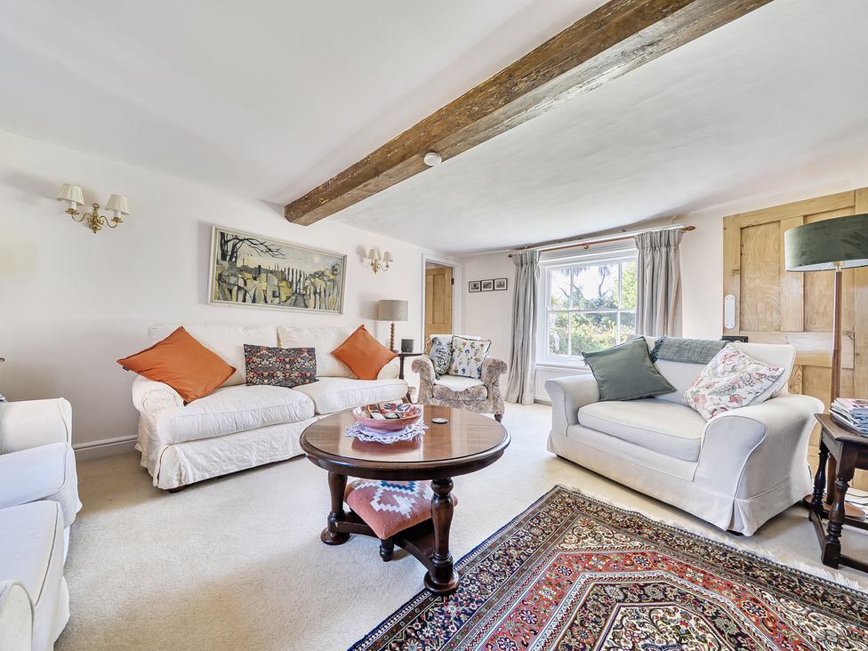 A living room with seating and a coffee table at Cutbush Farmhouse in Hingham