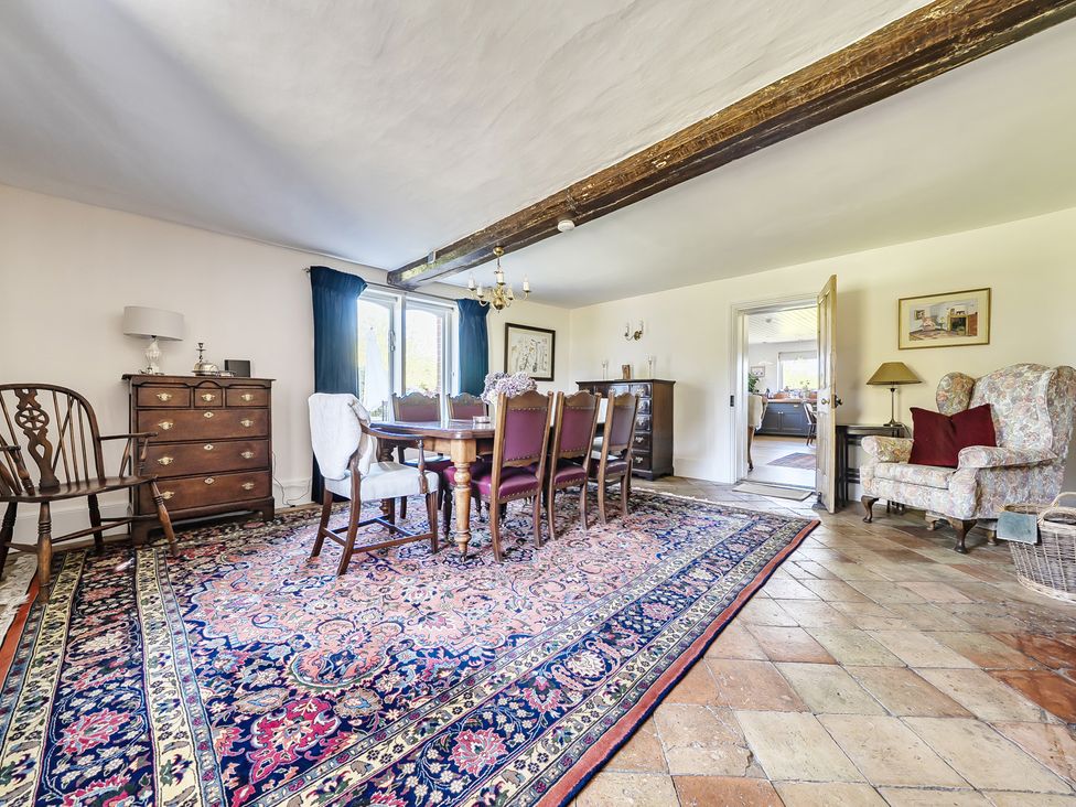 A dining room with a table and chairs at Cutbush Farmhouse in Hingham