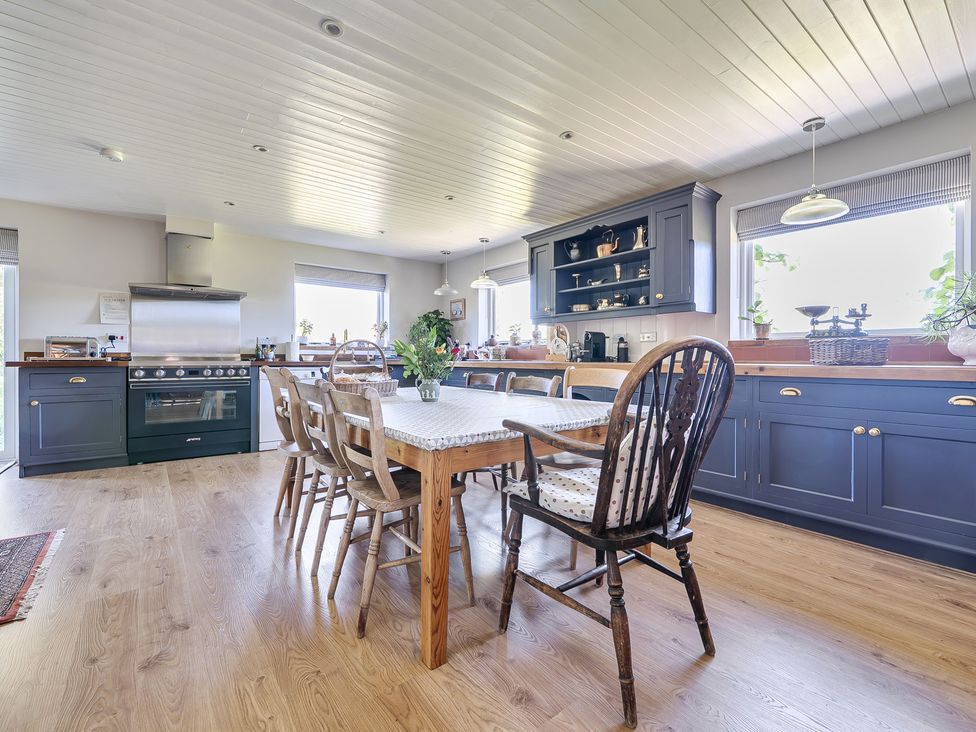 A kitchen with a dining table and chairs at Cutbush Farmhouse in Hingham