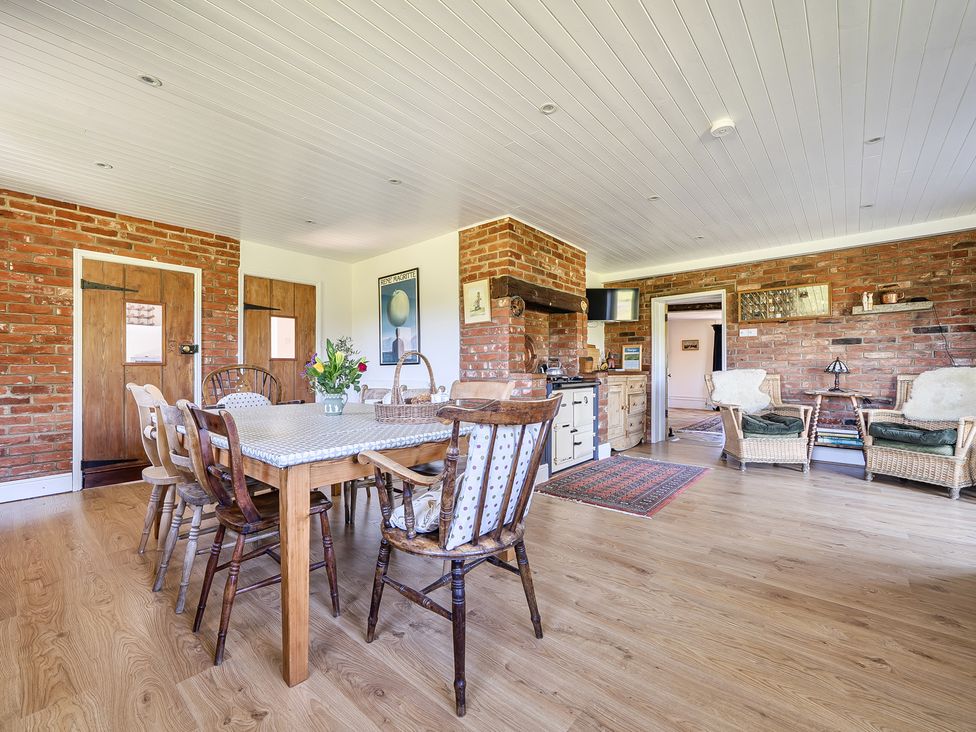 A dining room with a wooden table and chairs at Cutbush Farmhouse in Hingham