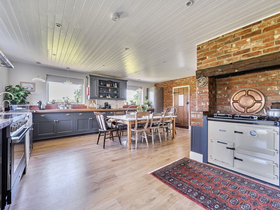 A kitchen with a dining table and chairs at Cutbush Farmhouse in Hingham