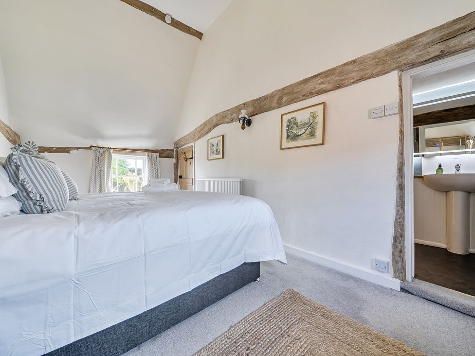 A bedroom with a bed and window at Cutbush Farmhouse in Hingham