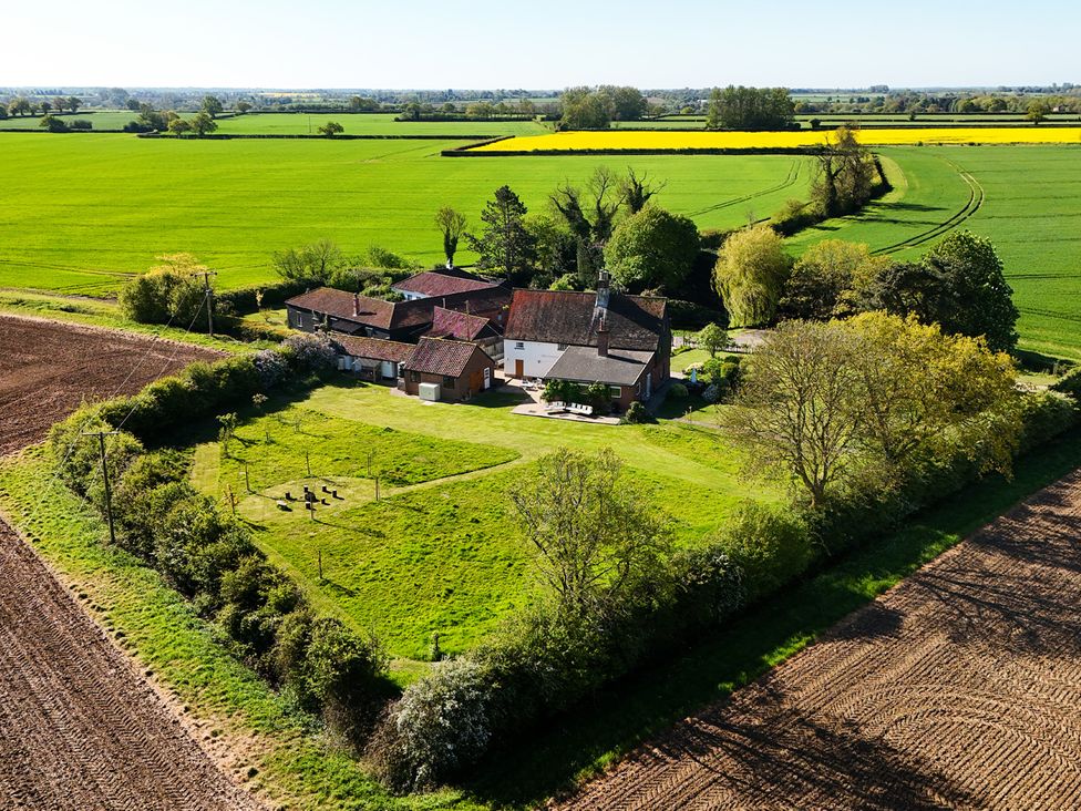 An outdoor view of a farmhouse surrounded by fields at Cutbush Farmhouse in Hingham