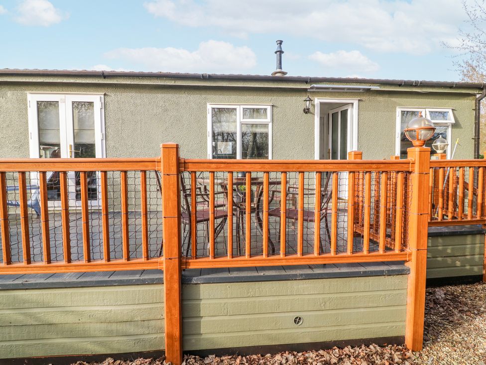 An outdoor area with a wooden deck and seating at The Nest Lodge 55 Grantham