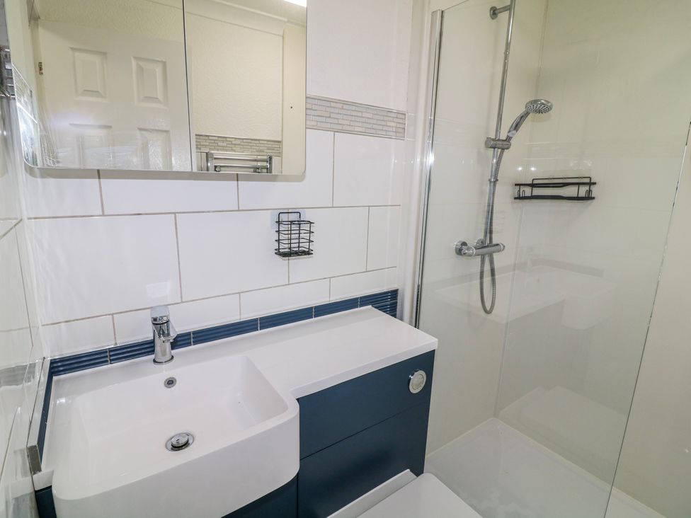 A bathroom with a sink and shower at The Nest Lodge 55 Grantham