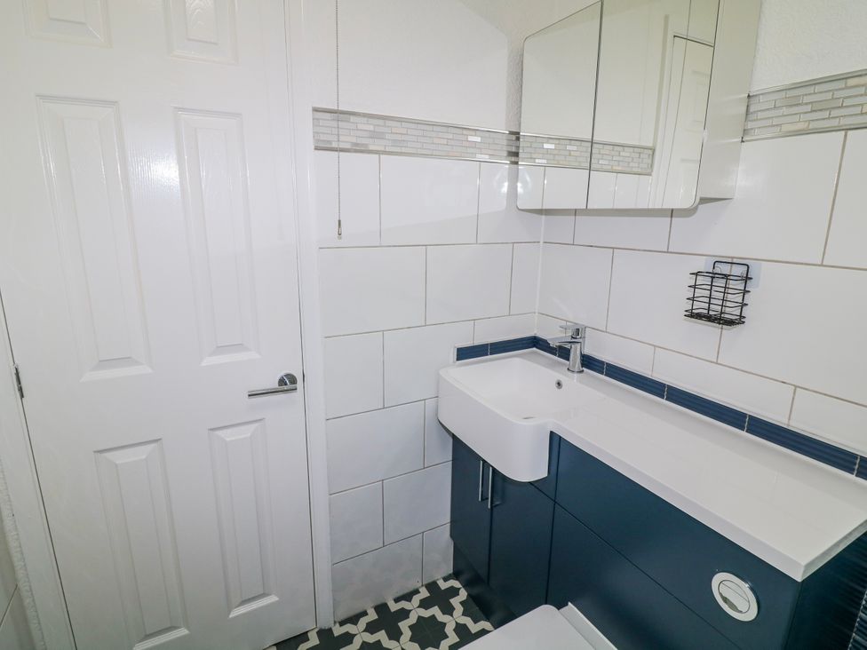 A bathroom with a sink and a mirror at The Nest Lodge 55 Grantham