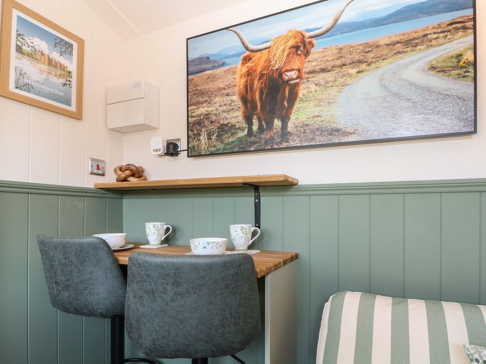 A dining room with a table and mugs at Salt Haven Shepards Hut Pevensey
