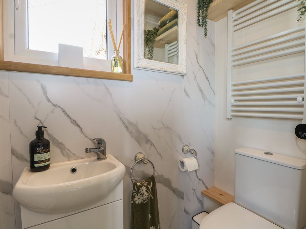 A bathroom with a sink and toilet at Salt Haven Shepards Hut Pevensey