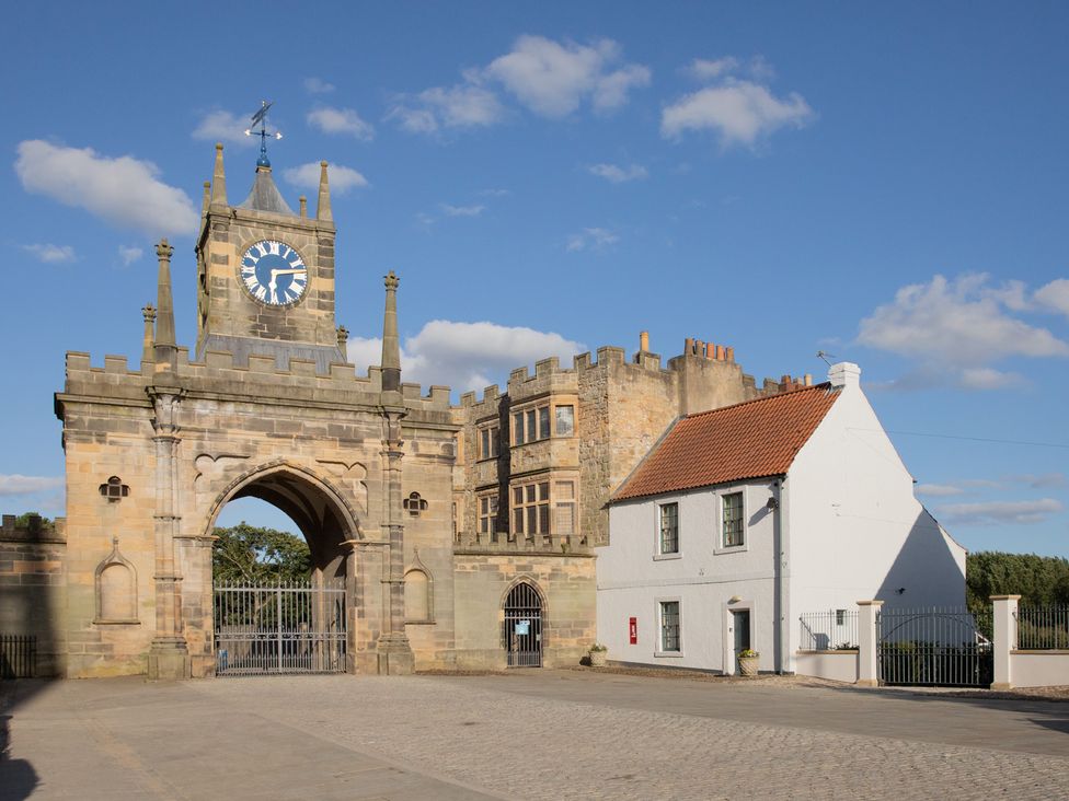 A clock tower and adjoining buildings at Palace Garden Cottage in Bishop Auckland