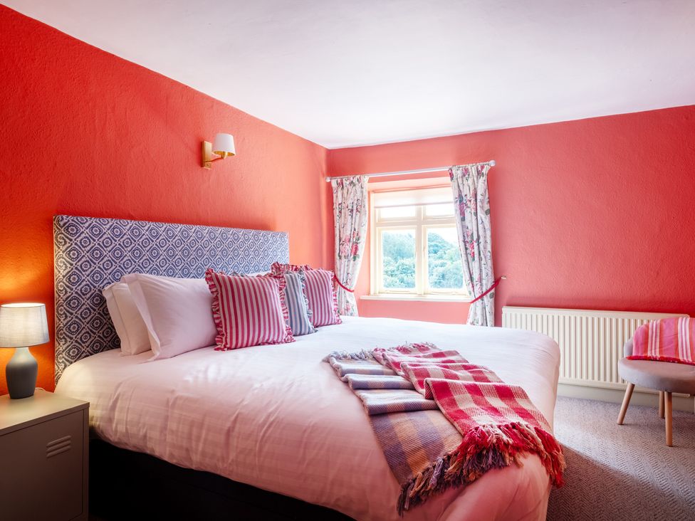 A bedroom with a bed and lamp at Palace Garden Cottage in Bishop Auckland