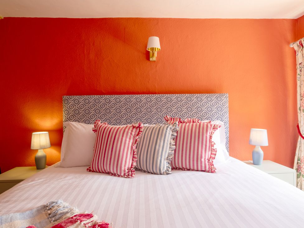 A bedroom with a bed and lamps at Palace Garden Cottage in Bishop Auckland
