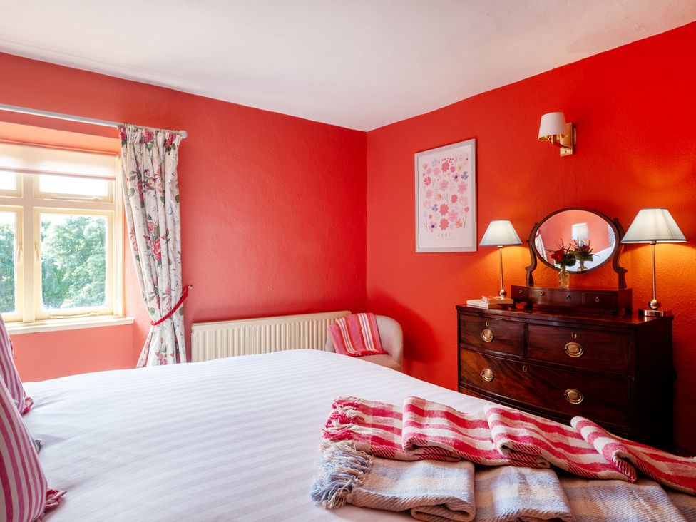 A bedroom with a bed and window at Palace Garden Cottage in Bishop Auckland