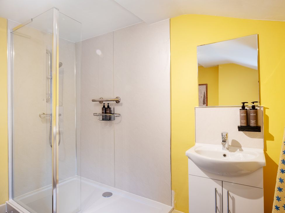 A bathroom with a shower and sink at Palace Garden Cottage in Bishop Auckland