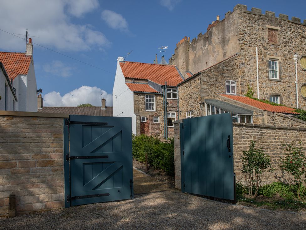 A view of a stone wall and doors at Palace Garden Cottage in Bishop Auckland