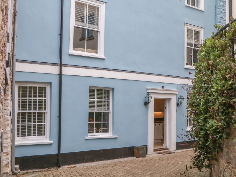Exterior view of a blue wall with windows and door at Dennings House, Mayors Avenue in Dartmouth