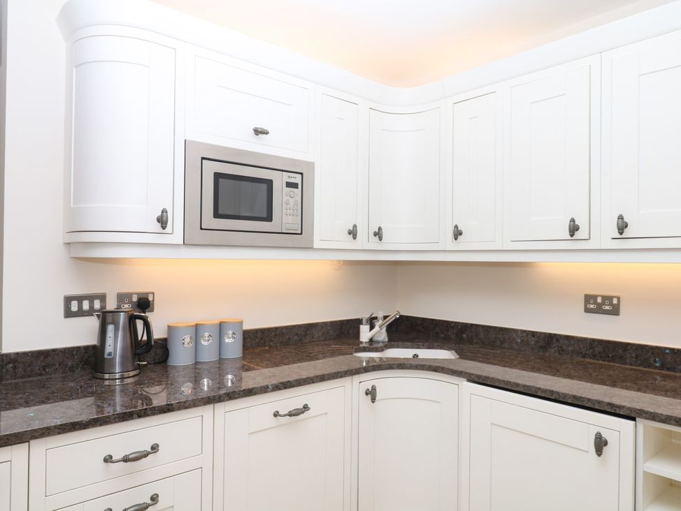 A kitchen with a kettle and microwave at Dennings House, Mayors Avenue in Dartmouth