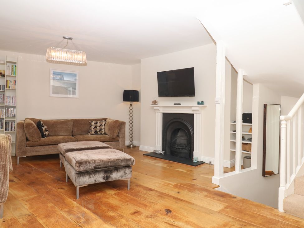 A living room with a sofa and television at Dennings House, Mayors Avenue in Dartmouth