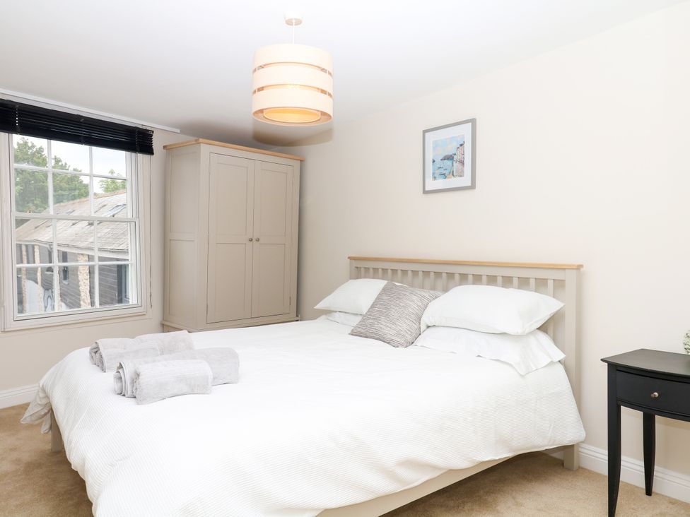 A bedroom with a bed and wardrobe at Dennings House, Mayors Avenue in Dartmouth