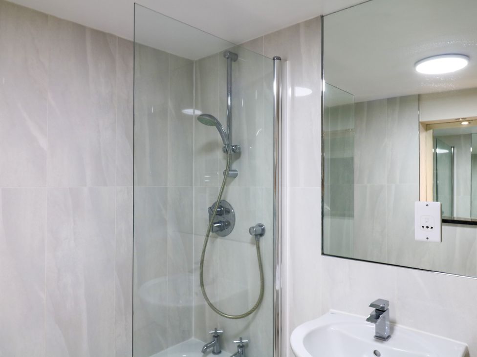 A bathroom with a shower and sink at Dennings House, Mayors Avenue, Dartmouth