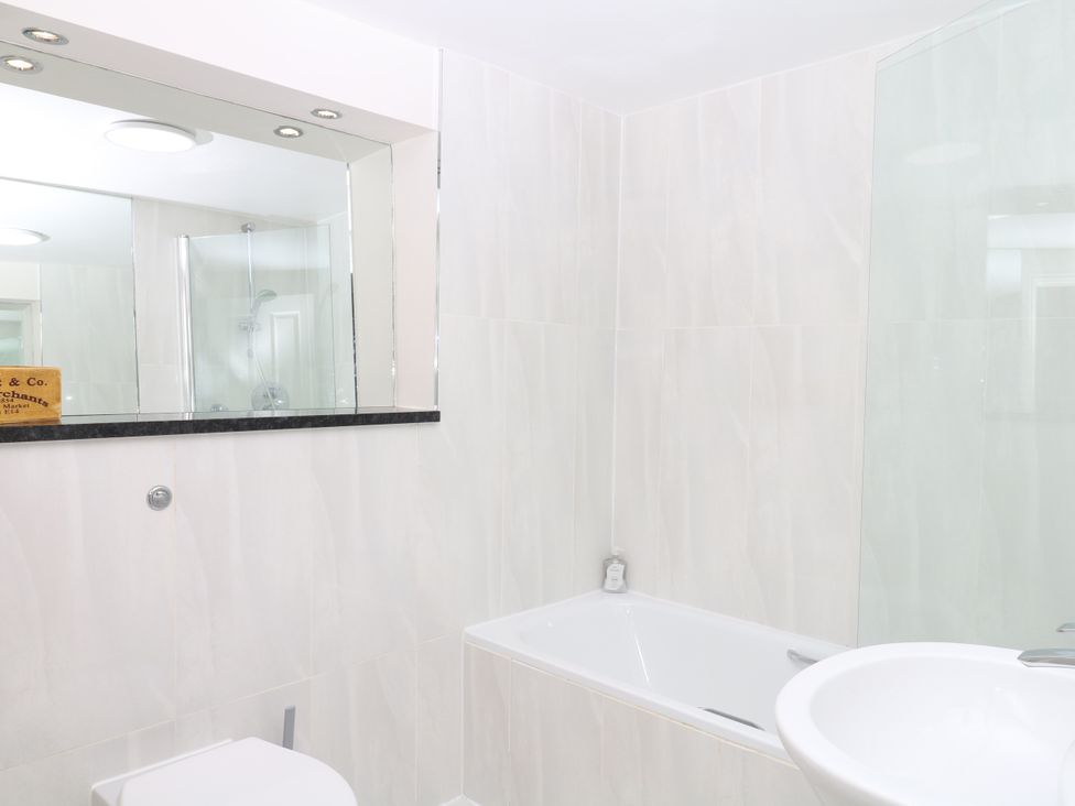 A bathroom featuring a bathtub, toilet, and sink at Dennings House, Mayors Avenue, Dartmouth