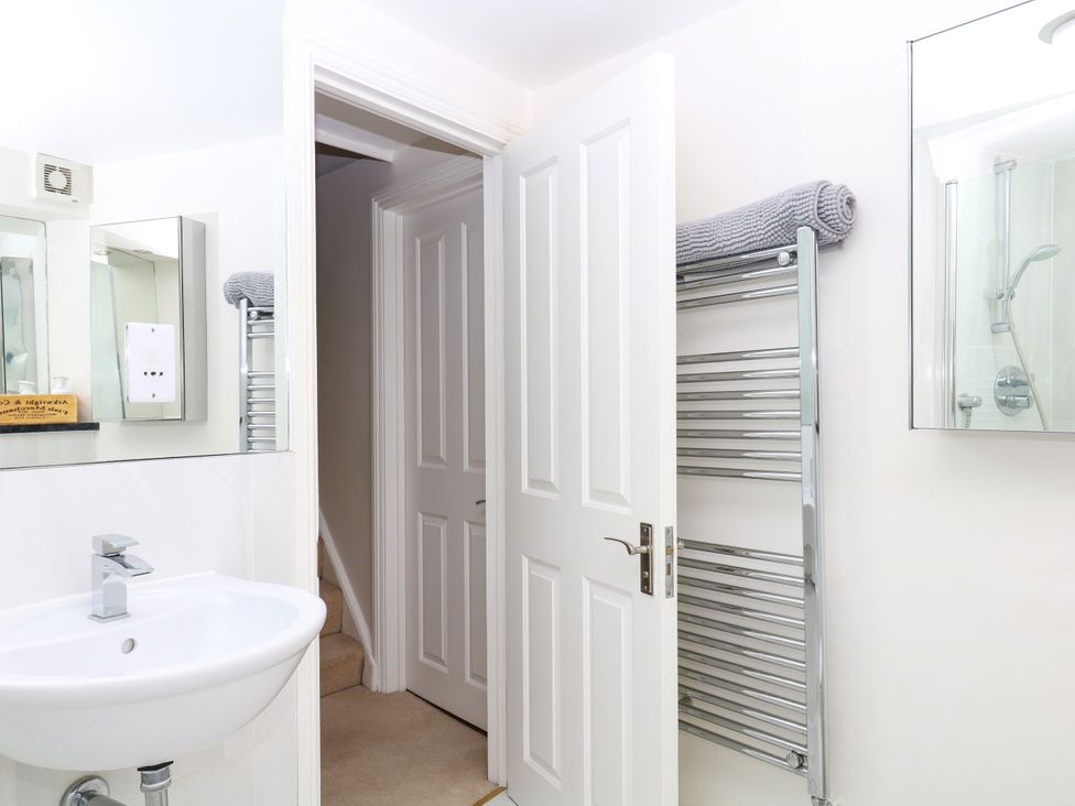 A bathroom with a wash basin and towel rack at Dennings House, Mayors Avenue, Dartmouth