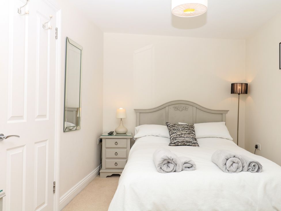 A bedroom with a bed and nightstand at Dennings House, Mayors Avenue, Dartmouth